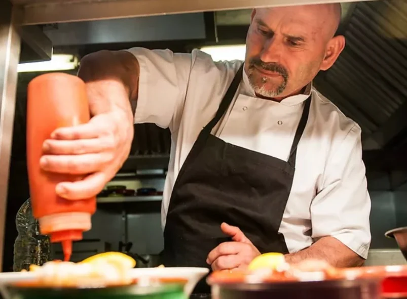 Beni preparing food in the Los Reyes kitchen