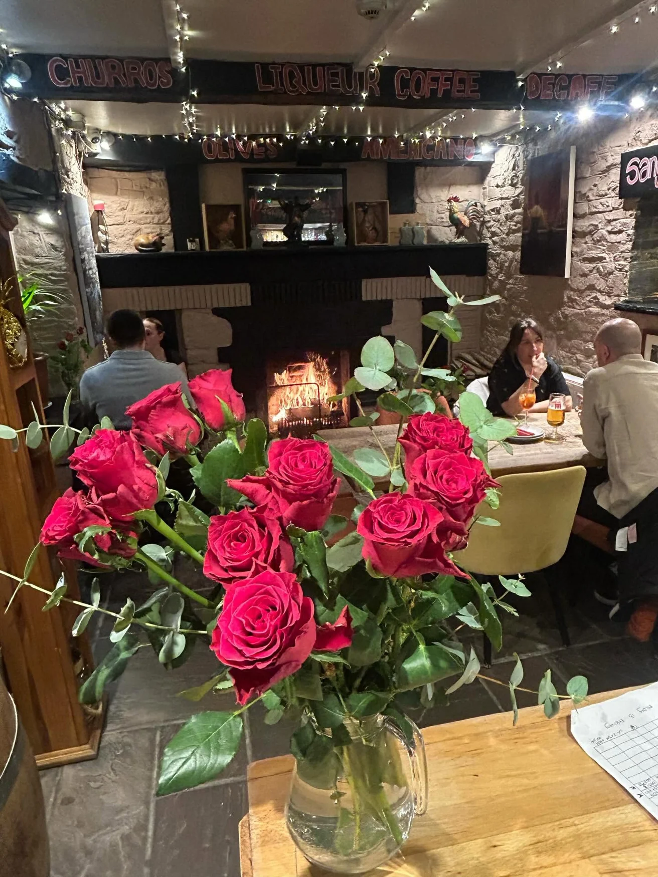 Flowers and diners inside Los Reyes tapas restaurant